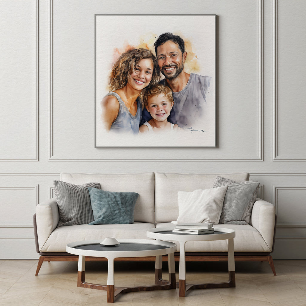 A framed custom watercolor family portrait hangs on a light gray paneled wall above a modern beige sofa with gray and blue pillows in a styled living room.