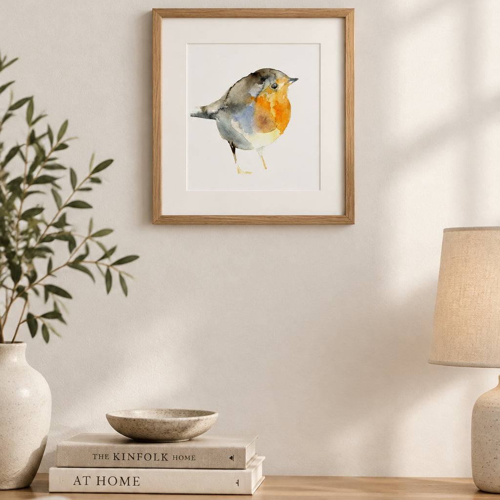 Watercolor painting of a robin bird in profile, featuring a gray-brown back, blue-gray wings, and a bright orange-red breast, on a plain white background.