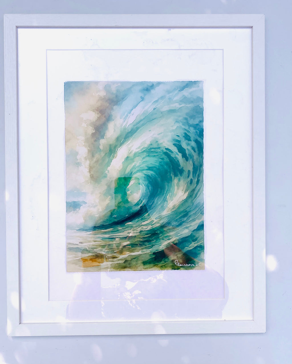 Framed artwork of a swirling wave on a light blue background