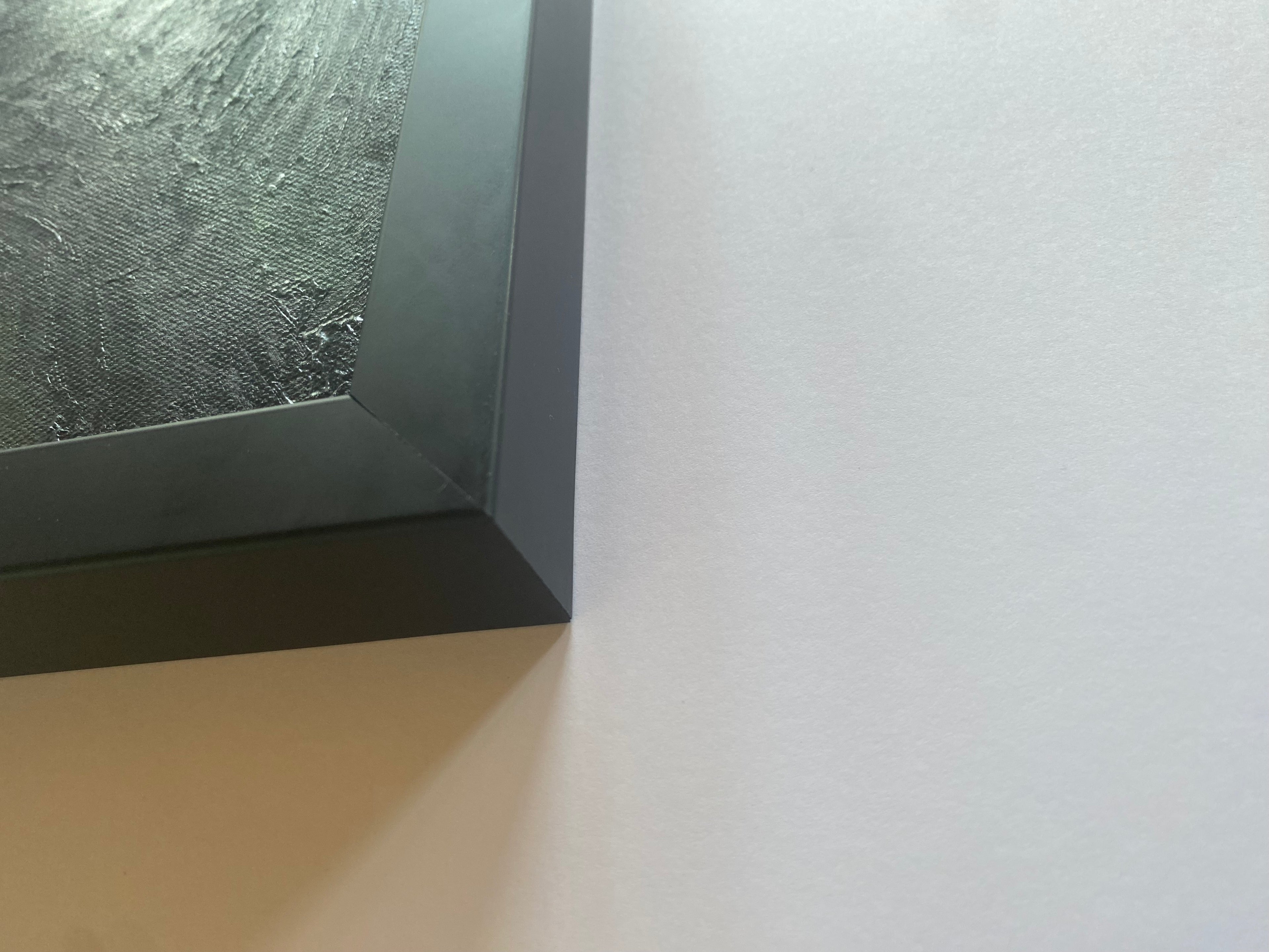 Close-up of a textured frame corner on a white background