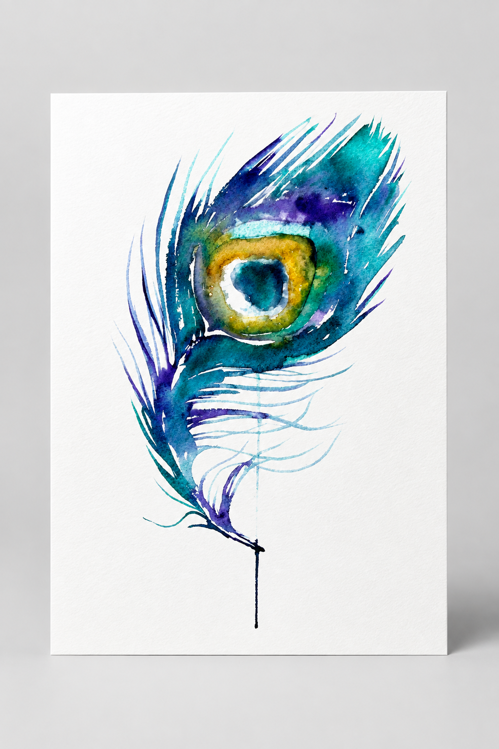 A vertical watercolor art print of a peacock feather on a white background, displayed against a neutral gray wall.