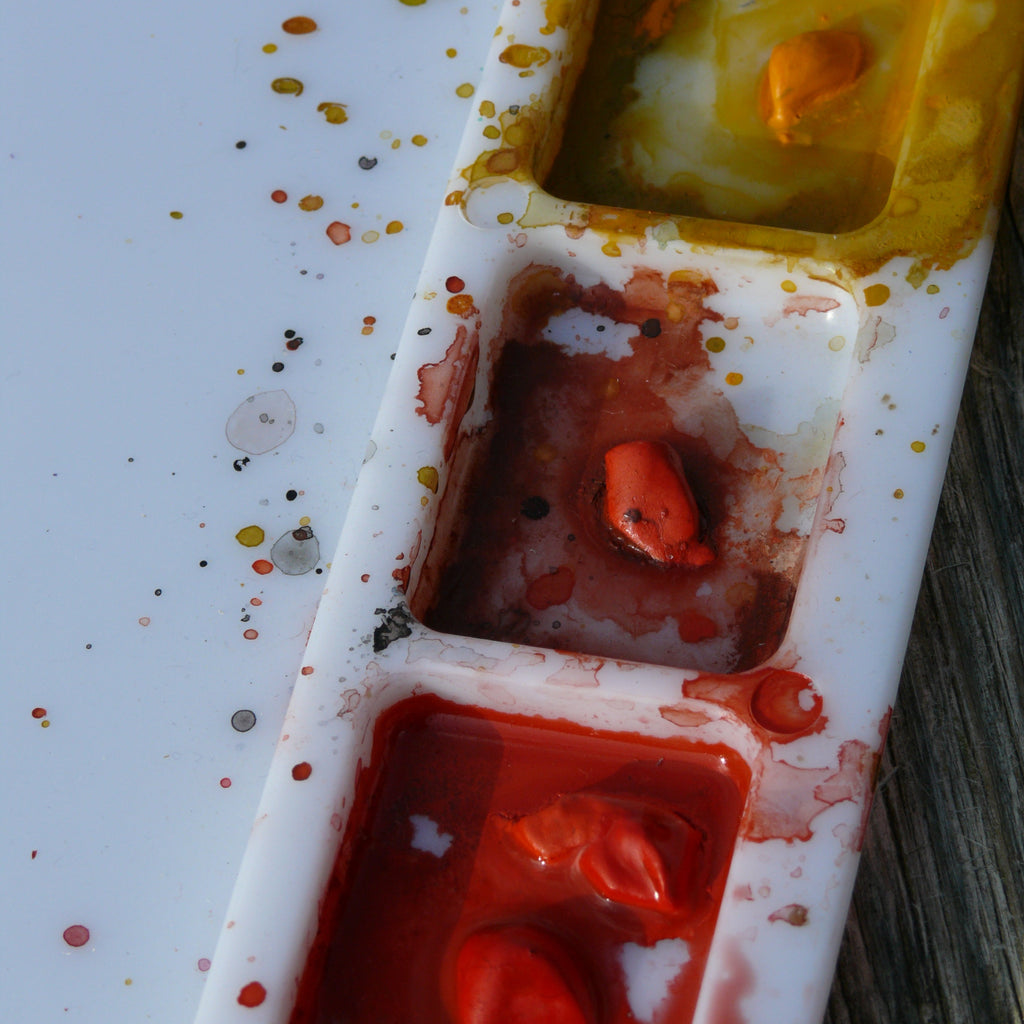 Paint palette with red, orange, and yellow paint splashes romalena art